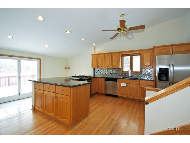35W503 Riverside Drive St. Charles, IL 60174 - Photo 2 of 10 a kitchen with stainless steel appliances kitchen island granite countertop a stove a sink and a refrigerator