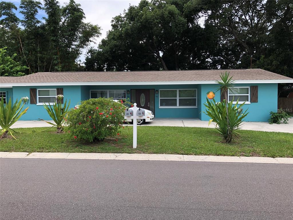 433 James Street, Unit 435 Dunedin, FL 34698 - Photo 1 of 1 a front view of house with yard and green space