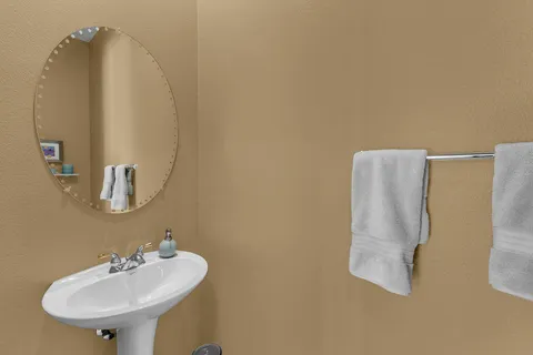 a white toilet sitting next to a white wall