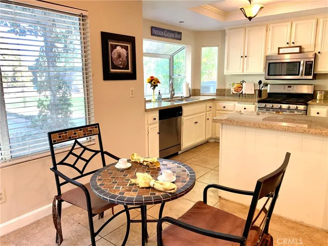 a kitchen with a dining table and chairs