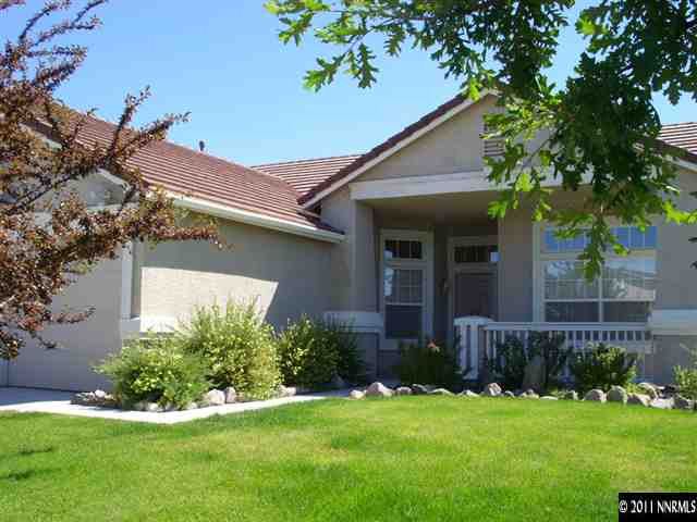 1765 Canyonlands Way Reno, NV 89521 - Photo 1 of 12 a front view of a house with a yard and garage