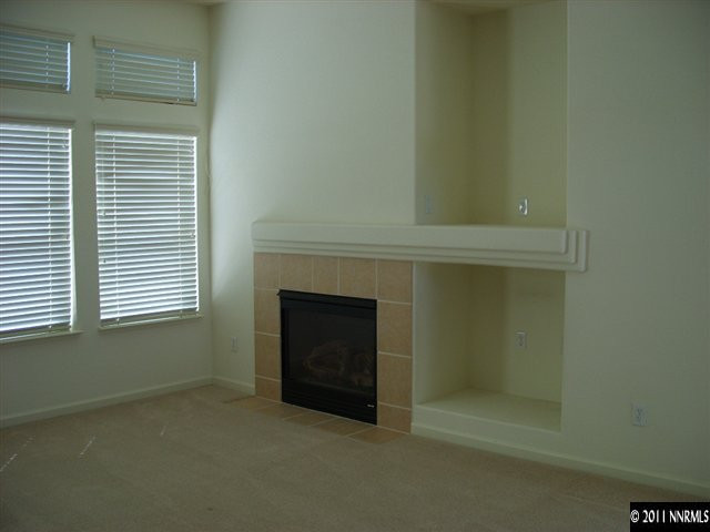1765 Canyonlands Way Reno, NV 89521 - Photo 6 of 12 a view of an empty room with a fireplace and a window