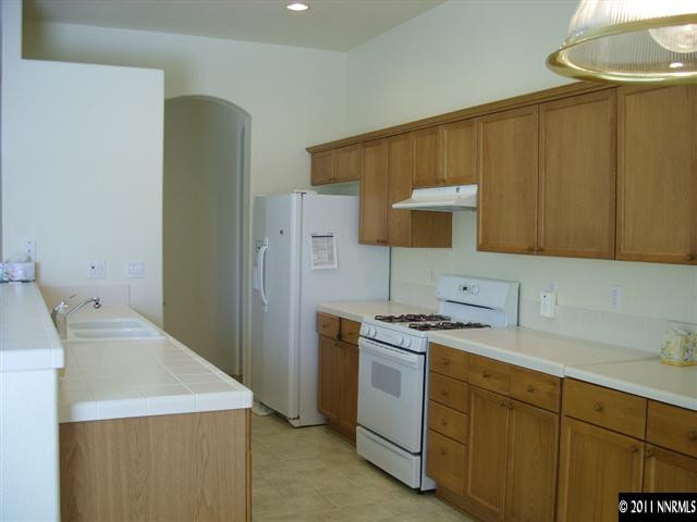 1765 Canyonlands Way Reno, NV 89521 - Photo 8 of 12 a utility room with cabinets washer and dryer