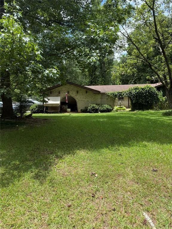 324 Piper Road Covington, GA 30014 - Photo 2 of 19 a front view of a house with a yard