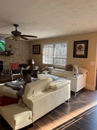 a living room with furniture and a large window