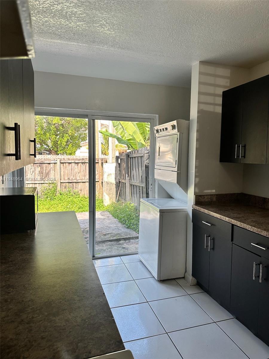 13993 Southwest 280th Terrace Homestead, FL 33033 - Photo 21 of 22 a kitchen with stainless steel appliances granite countertop a stove a sink and a microwave