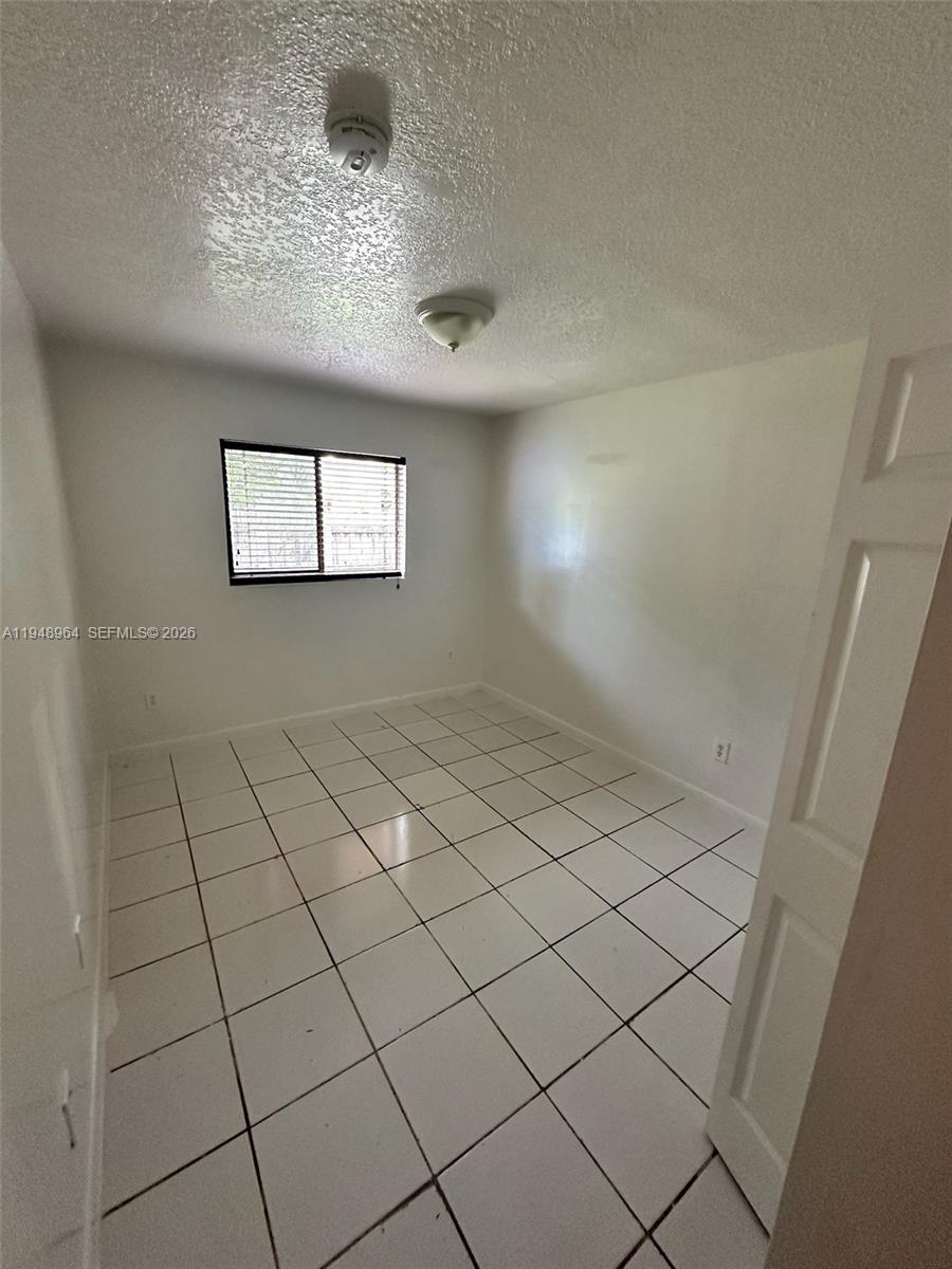 13993 Southwest 280th Terrace Homestead, FL 33033 - Photo 10 of 22 a view of an empty room and window
