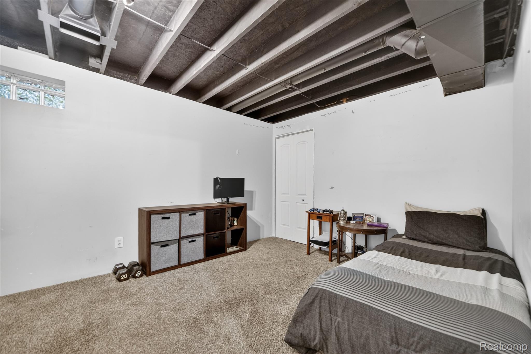 13635 Unadilla Road Gregory, MI 48137 - Photo 33 of 68 Carpeted room with a painted white door and an exposed ceiling