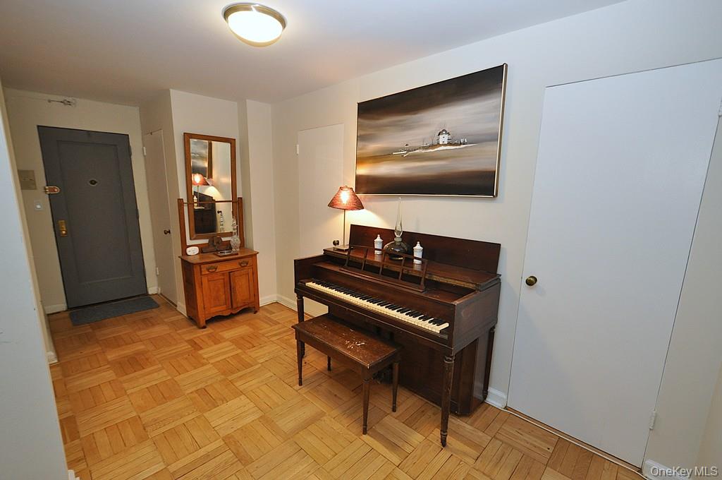 235 Garth Road, Unit A5B Scarsdale, NY 10583 - Photo 28 of 47 a living room with furniture and a piano