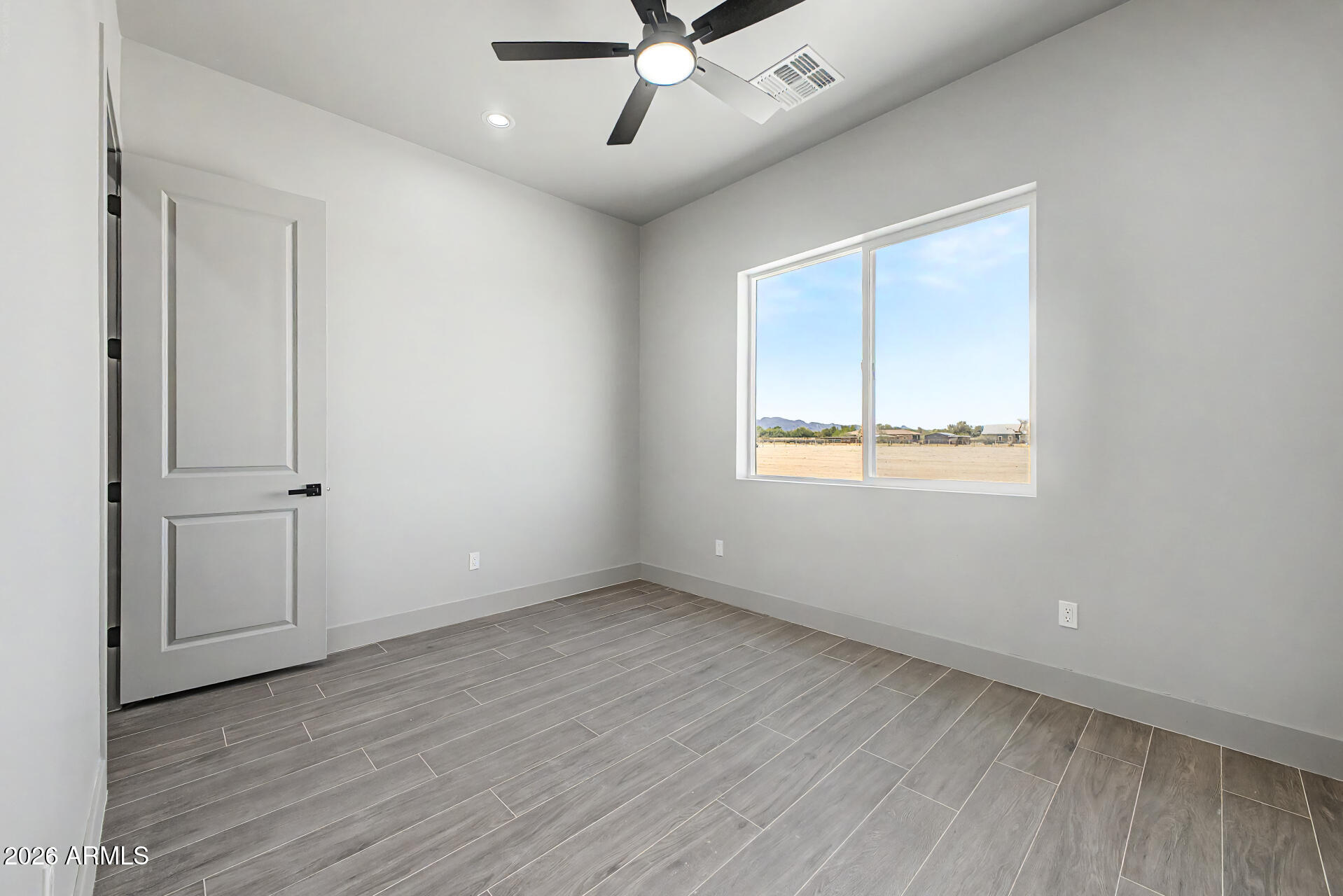 40461 West Robles Road Stanfield, AZ 85172 - Photo 41 of 54 wooden floor in an empty room with a window