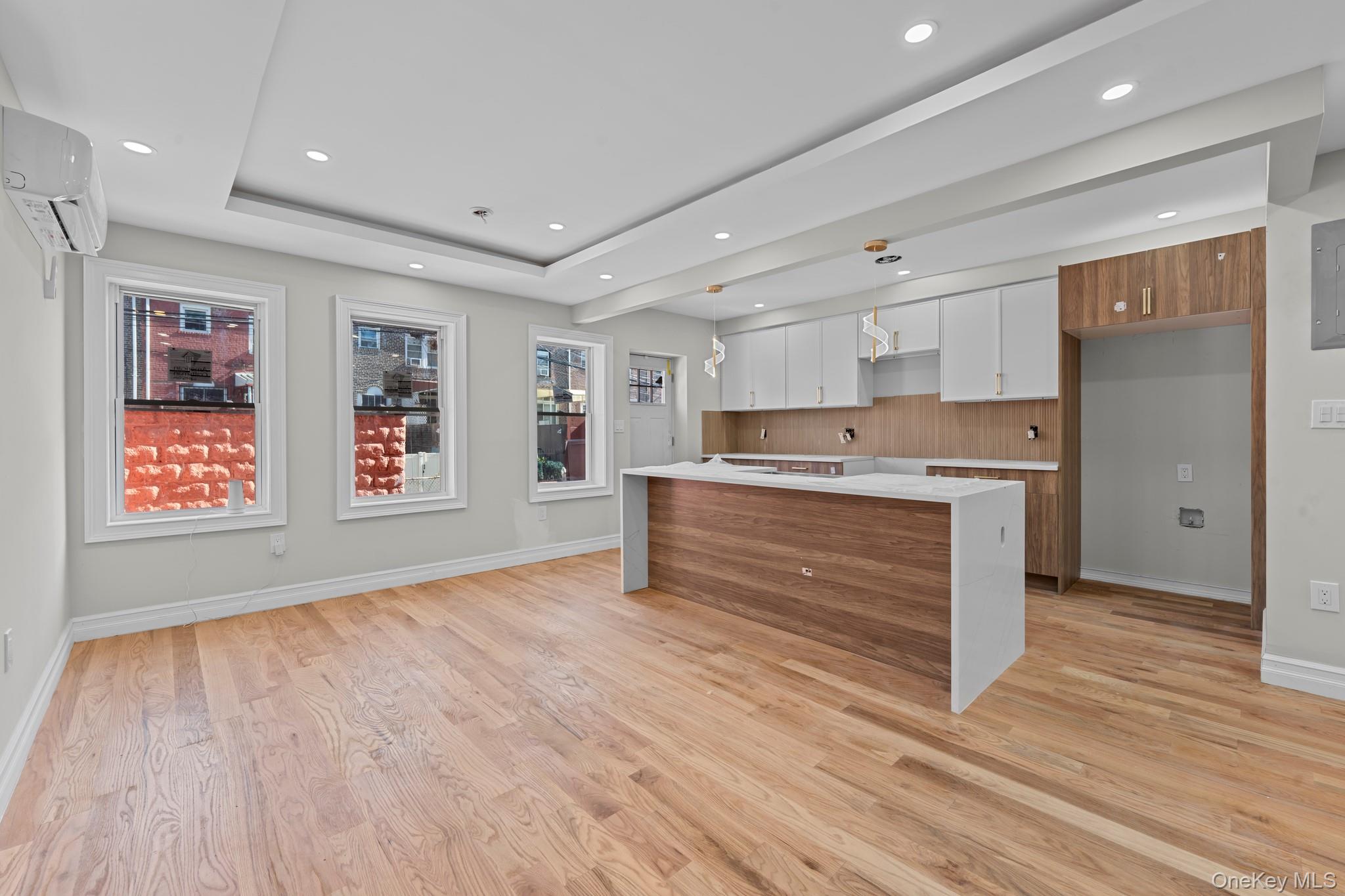 179-18 Selover Road Queens, NY 11434 - Photo 1 of 18 Kitchen with modern cabinets, brown cabinets, white cabinets, light stone countertops, and recessed lighting