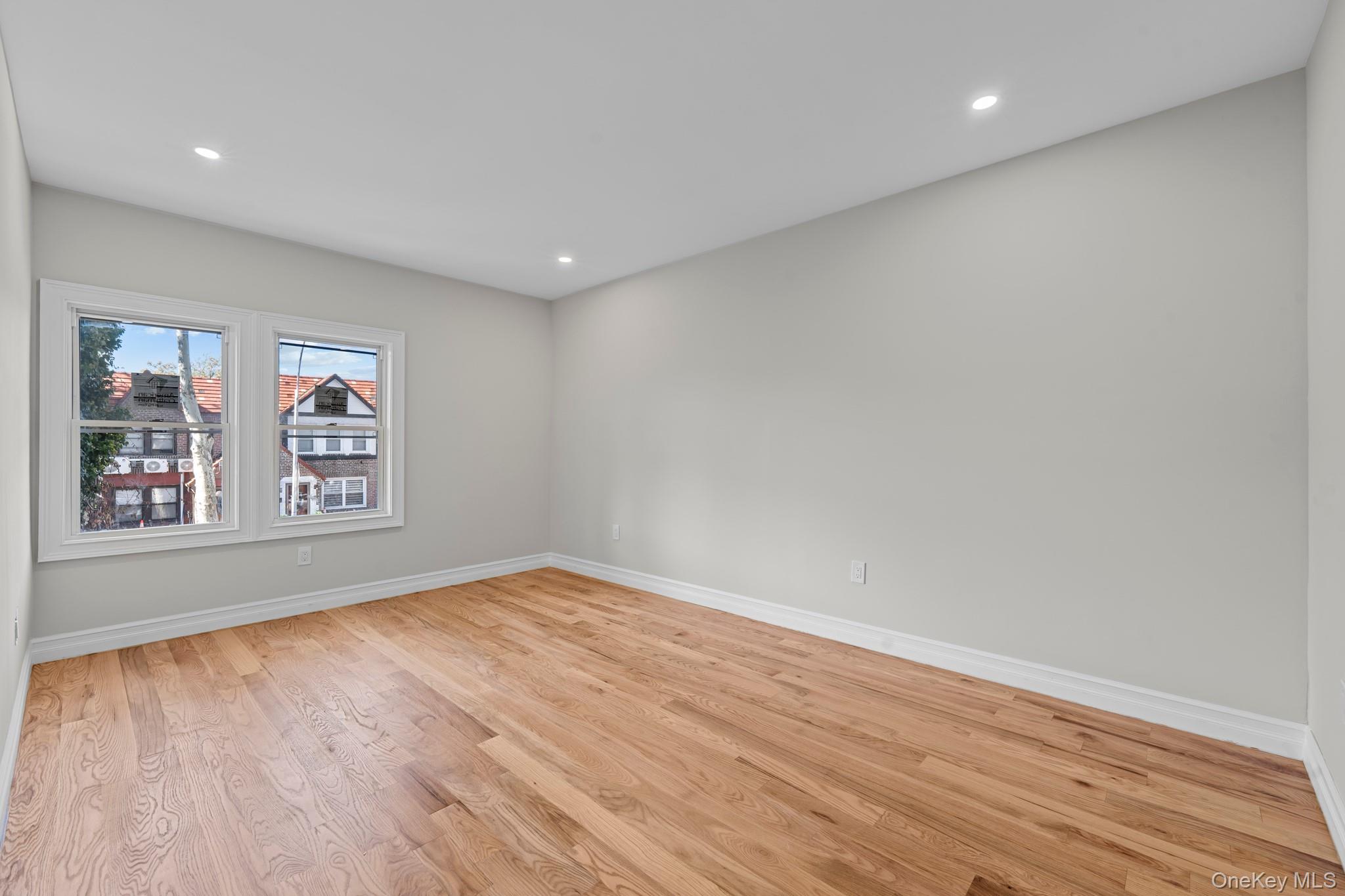 179-18 Selover Road Queens, NY 11434 - Photo 12 of 18 Empty room with light wood finished floors and recessed lighting
