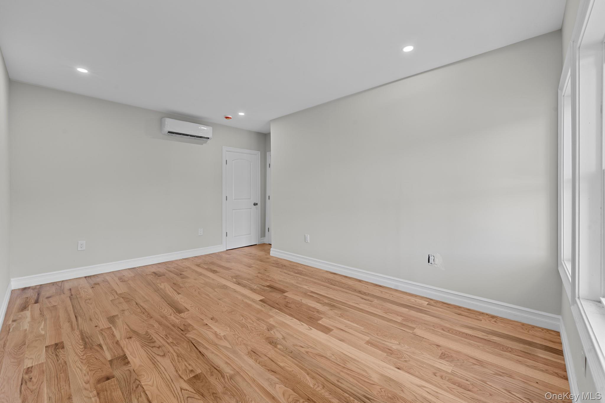 179-18 Selover Road Queens, NY 11434 - Photo 13 of 18 Empty room featuring light wood finished floors and recessed lighting
