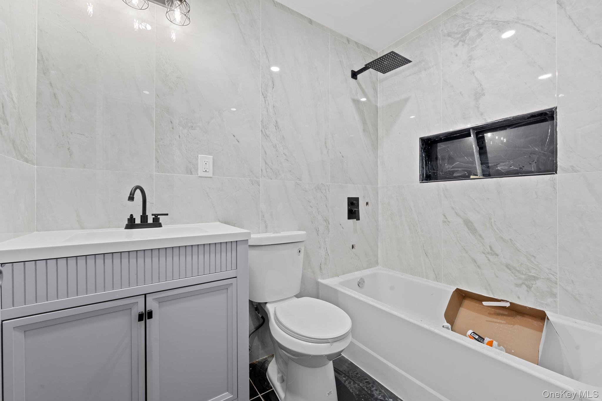 179-18 Selover Road Queens, NY 11434 - Photo 15 of 18 Bathroom with tile walls, vanity, and shower / bath combination