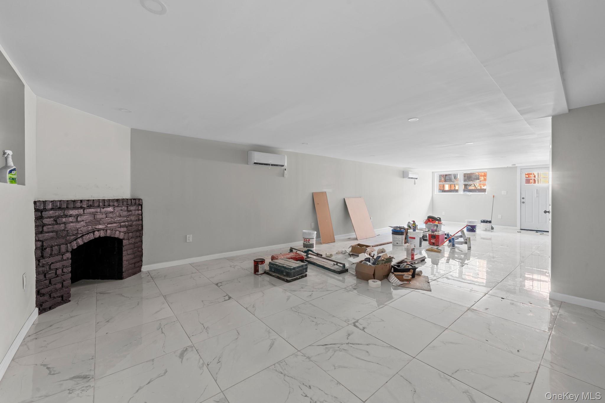 179-18 Selover Road Queens, NY 11434 - Photo 16 of 18 Living area with light marble finish flooring and a fireplace