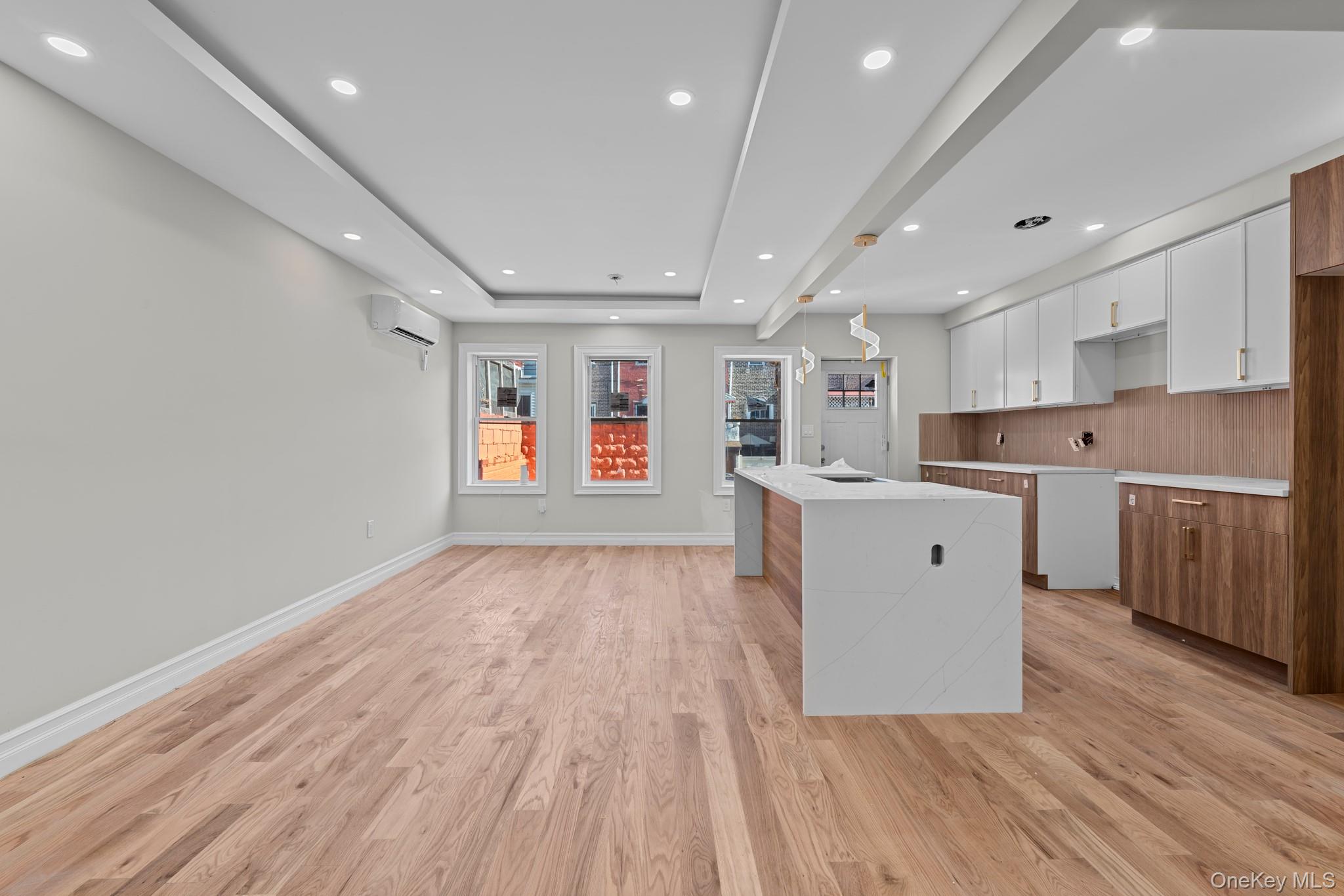 179-18 Selover Road Queens, NY 11434 - Photo 3 of 18 Kitchen featuring white cabinets, brown cabinetry, modern cabinets, and recessed lighting