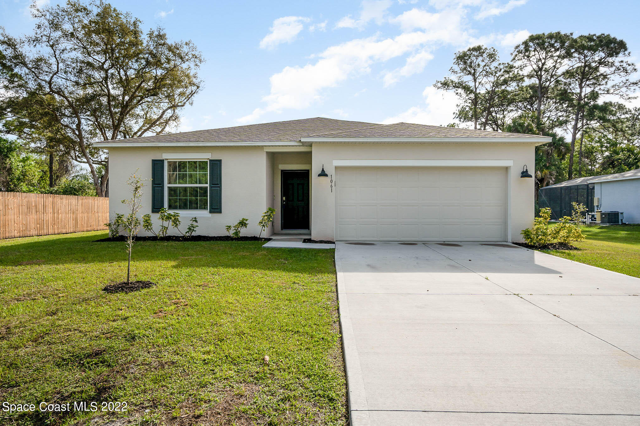 1061 Wabash Road Southeast Palm Bay, FL 32909 - Photo 1 of 22 a view of a house with backyard and trees