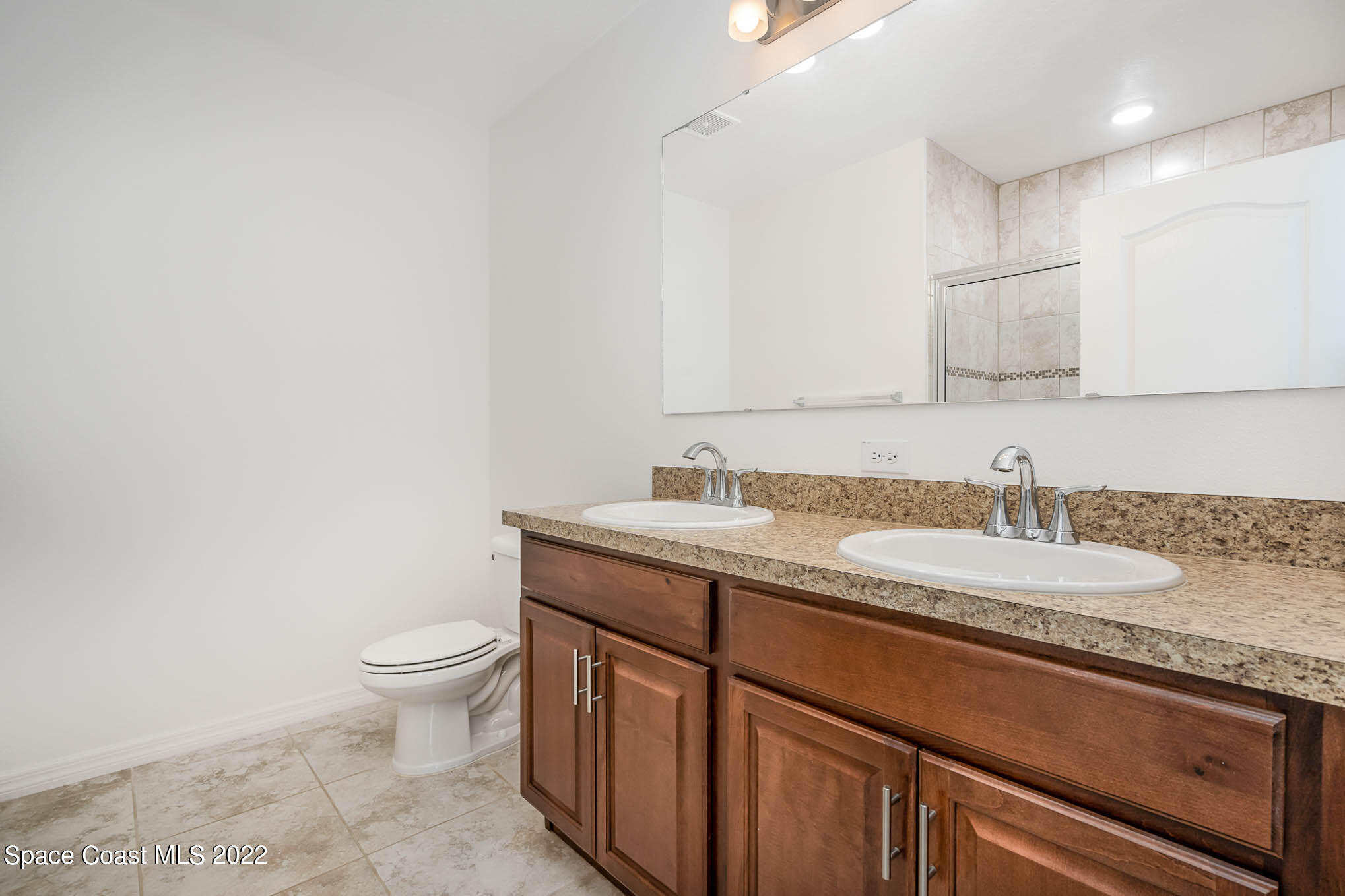 1061 Wabash Road Southeast Palm Bay, FL 32909 - Photo 11 of 22 a bathroom with a granite countertop sink and a toilet