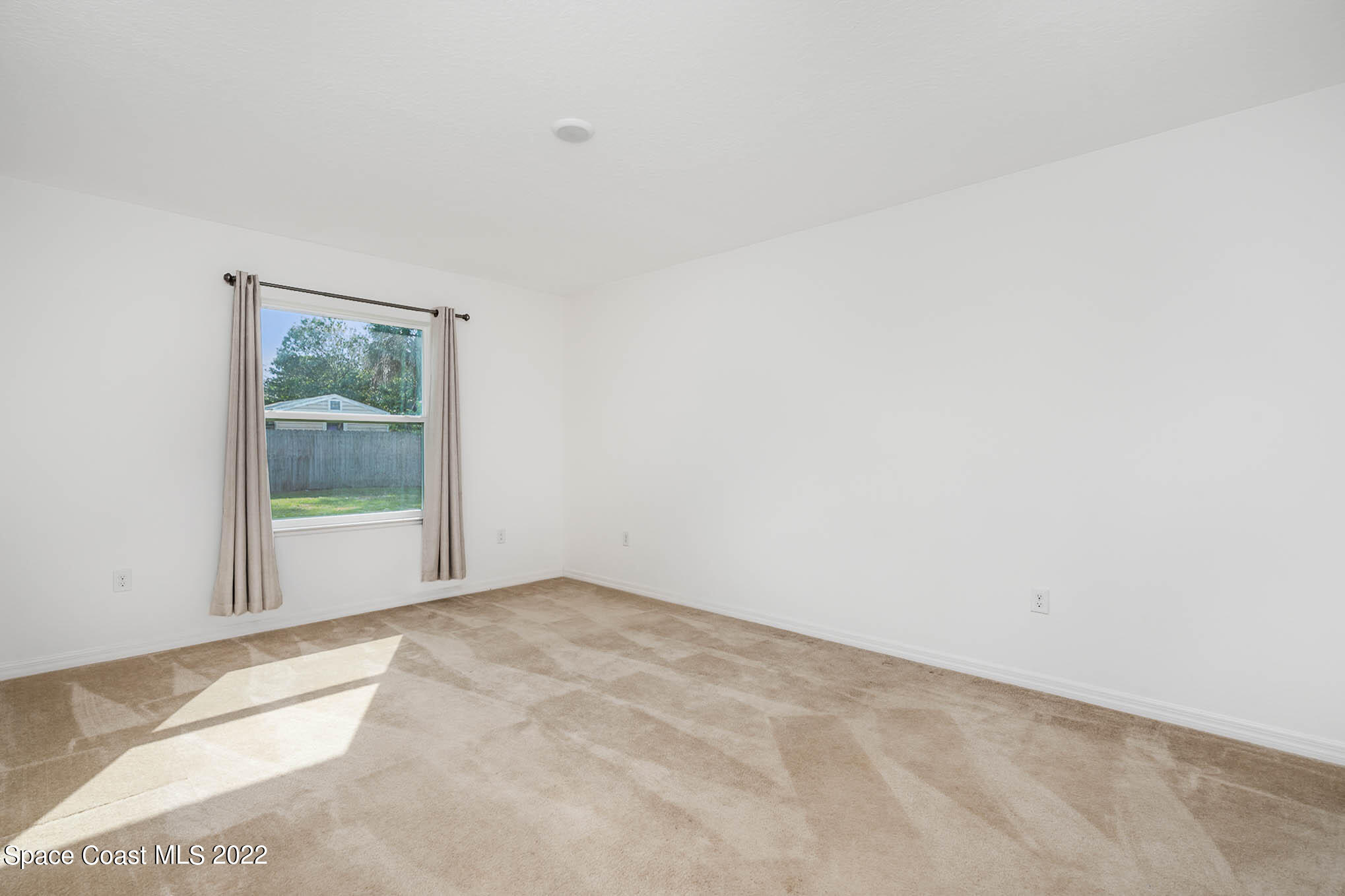 1061 Wabash Road Southeast Palm Bay, FL 32909 - Photo 16 of 22 a view of an empty room with a window