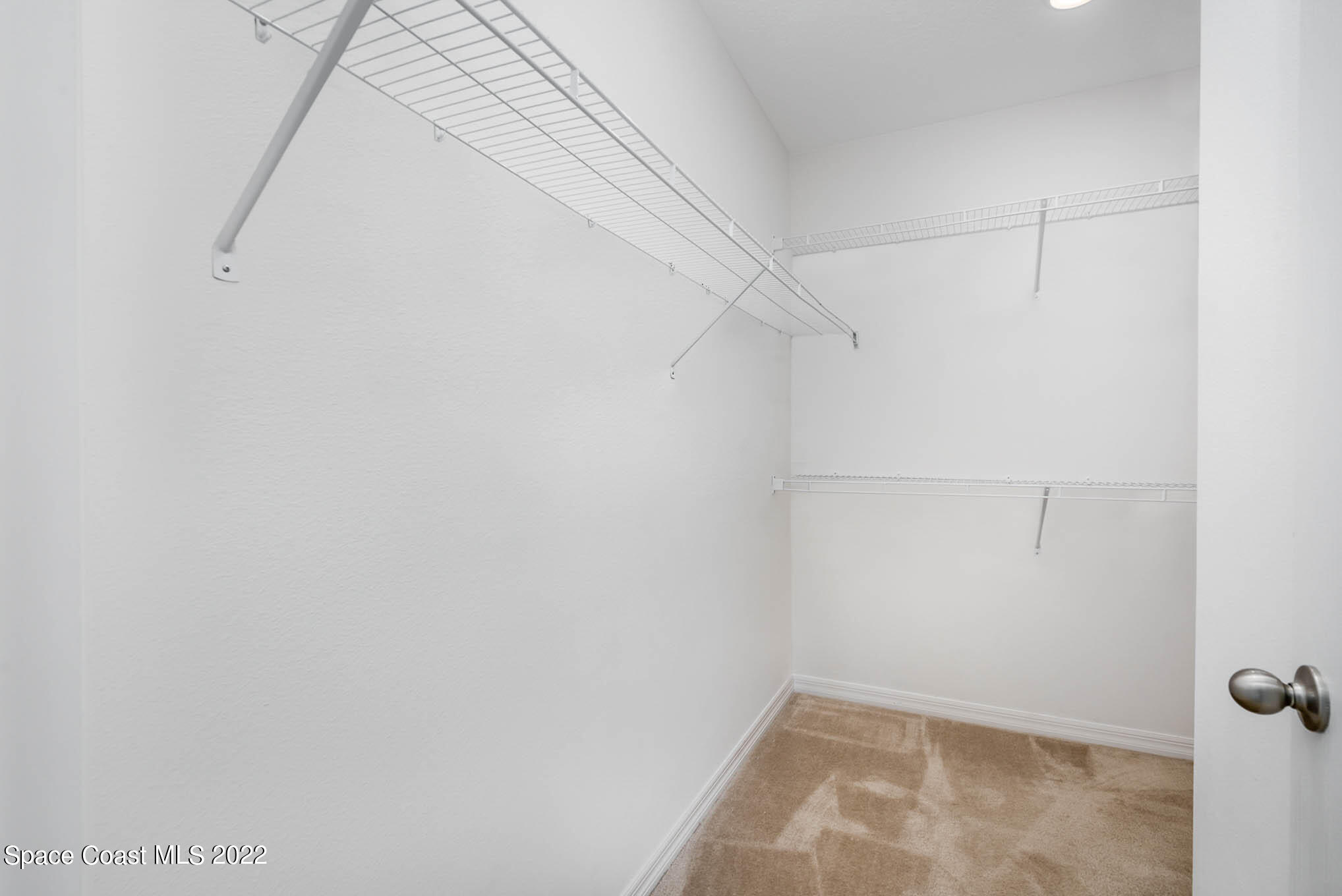 1061 Wabash Road Southeast Palm Bay, FL 32909 - Photo 18 of 22 a view of a room with racks on the wall