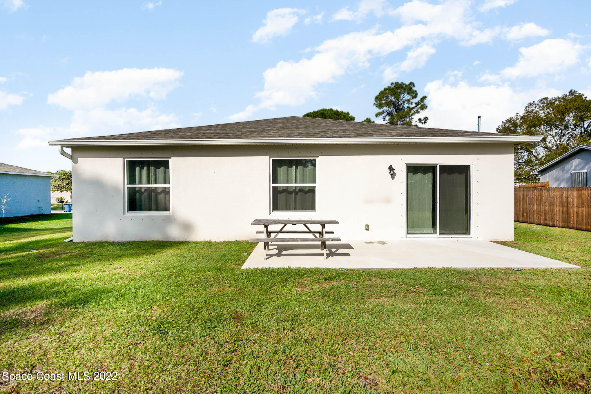 1061 Wabash Road Southeast Palm Bay, FL 32909 - Photo 20 of 22 a front view of a house with a garden and yard