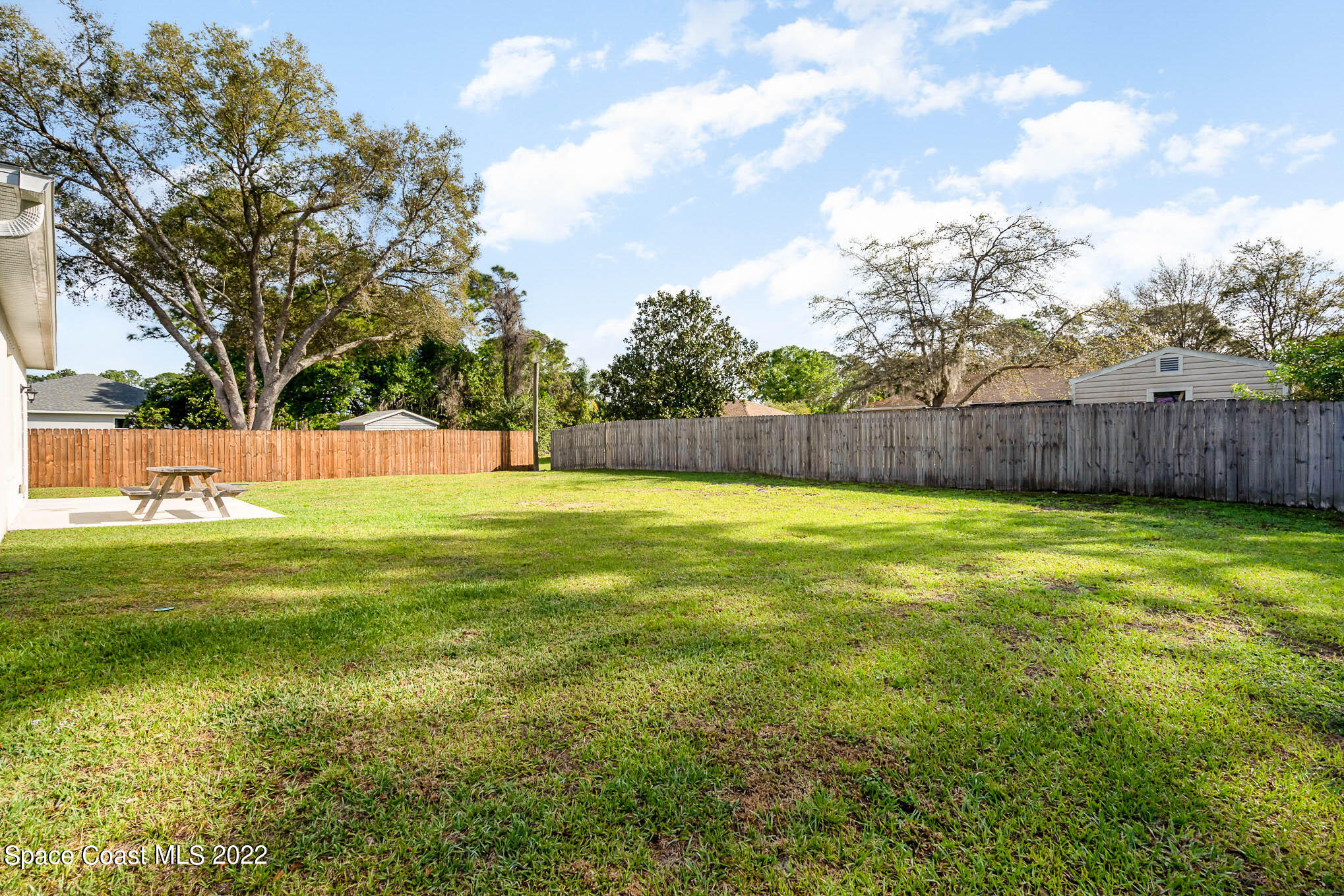 1061 Wabash Road Southeast Palm Bay, FL 32909 - Photo 22 of 22 a view of swimming pool with a big yard and large trees