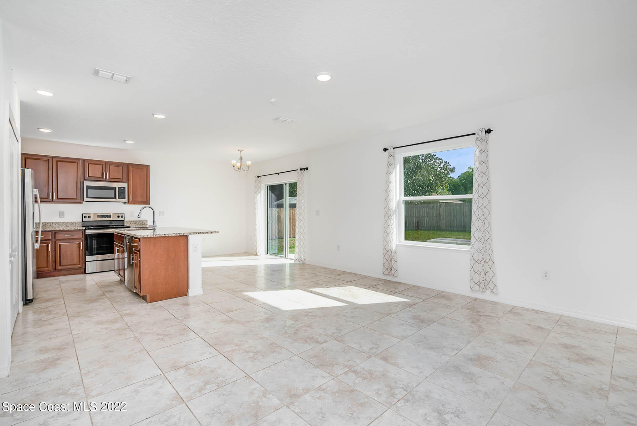 1061 Wabash Road Southeast Palm Bay, FL 32909 - Photo 3 of 22 a view of kitchen with stainless steel appliances granite countertop cabinets and window