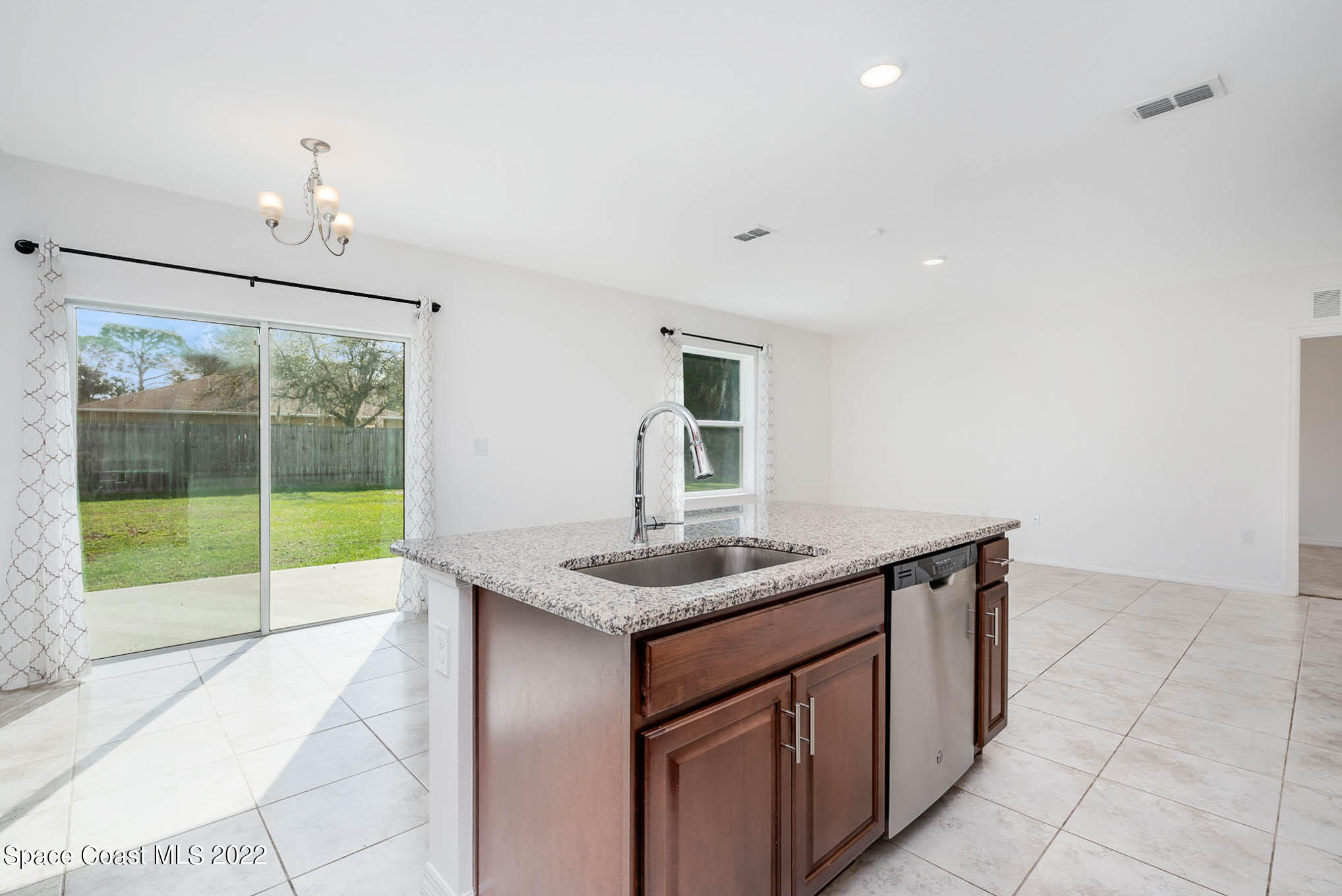 1061 Wabash Road Southeast Palm Bay, FL 32909 - Photo 7 of 22 a kitchen with a sink and a large window