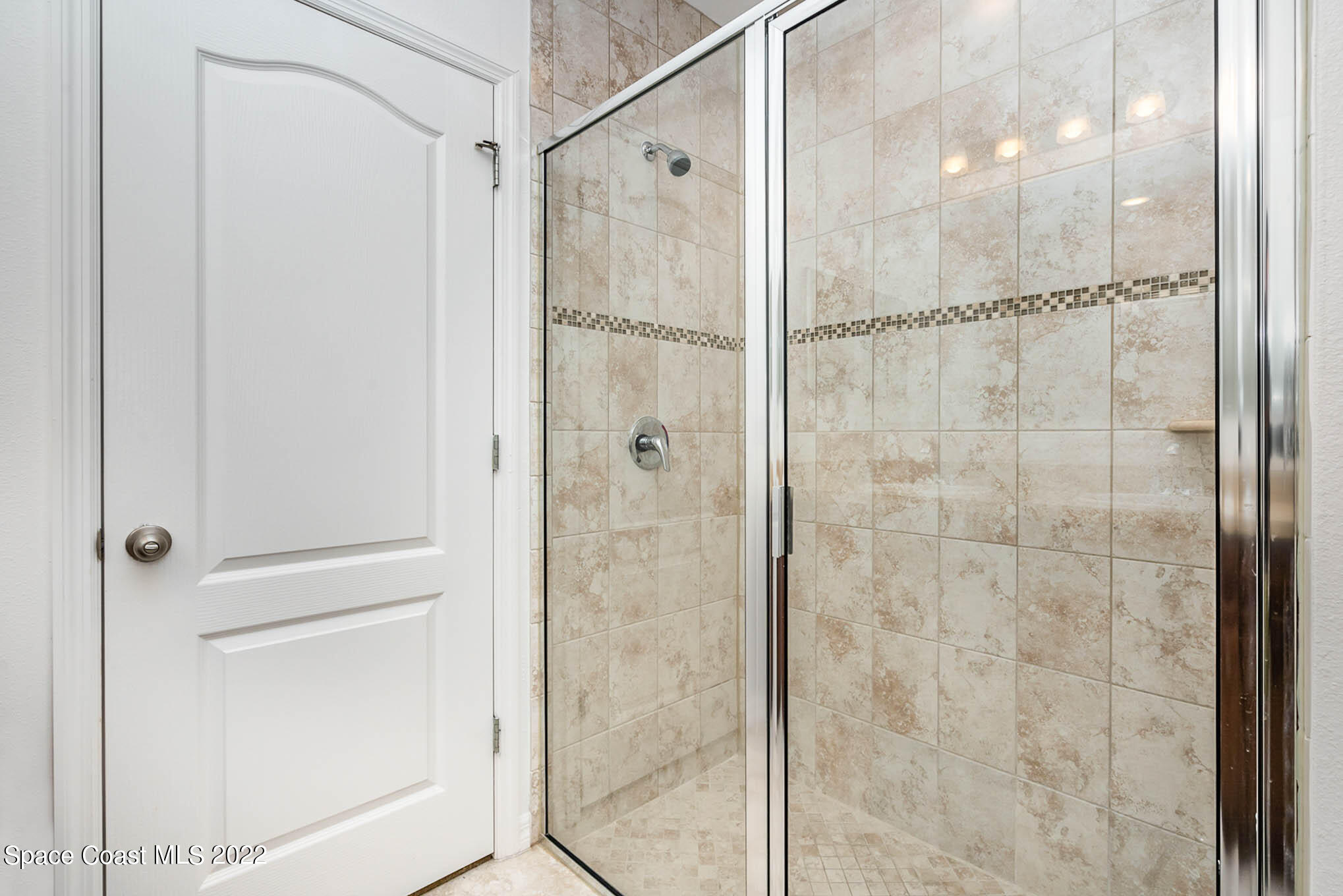 1061 Wabash Road Southeast Palm Bay, FL 32909 - Photo 10 of 22 a bathroom with a glass shower door