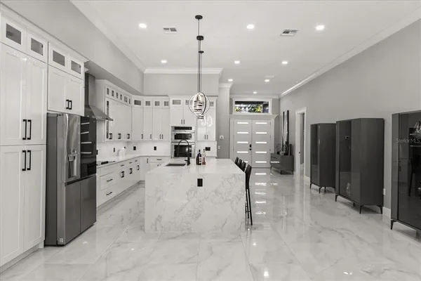 a bathroom with a granite countertop sink a mirror a bathtub and shower