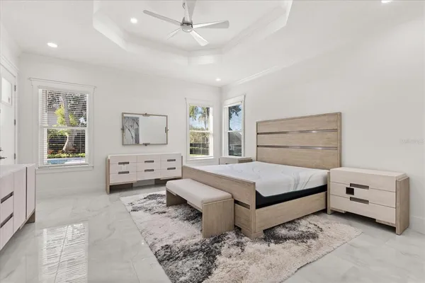 an empty room with windows and fan