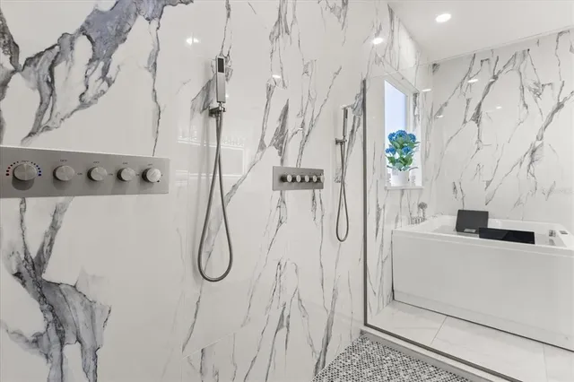 a bathroom with a granite countertop sink toilet and shower