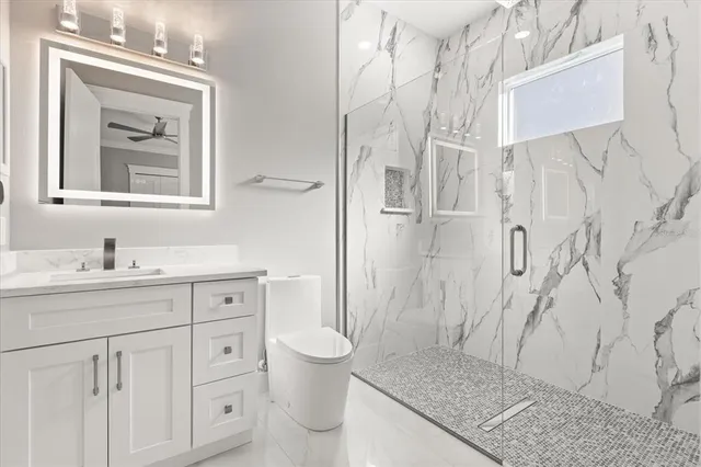 an aerial view of a residential houses with yard