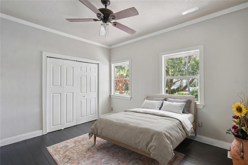 1048 North Grandview Street Mount Dora, FL 32757 - Photo 14 of 56 a bedroom with a bed and a window