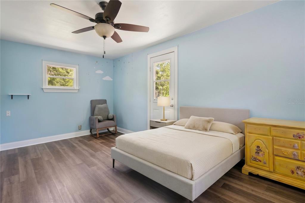 1048 North Grandview Street Mount Dora, FL 32757 - Photo 19 of 56 a bedroom with a bed and a window