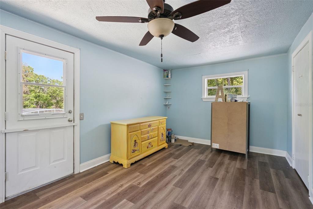 1048 North Grandview Street Mount Dora, FL 32757 - Photo 20 of 56 wooden floor in an empty room with a window