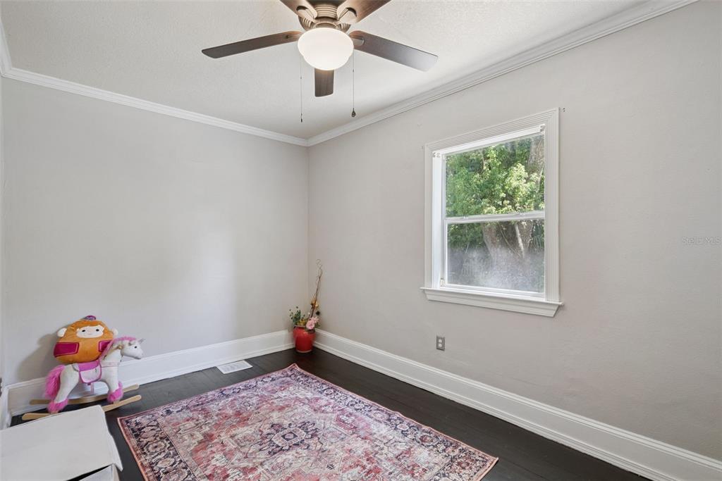 1048 North Grandview Street Mount Dora, FL 32757 - Photo 23 of 56 an empty room with fan and window