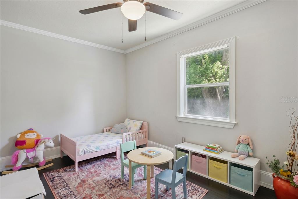 1048 North Grandview Street Mount Dora, FL 32757 - Photo 24 of 56 a living room with furniture and a window