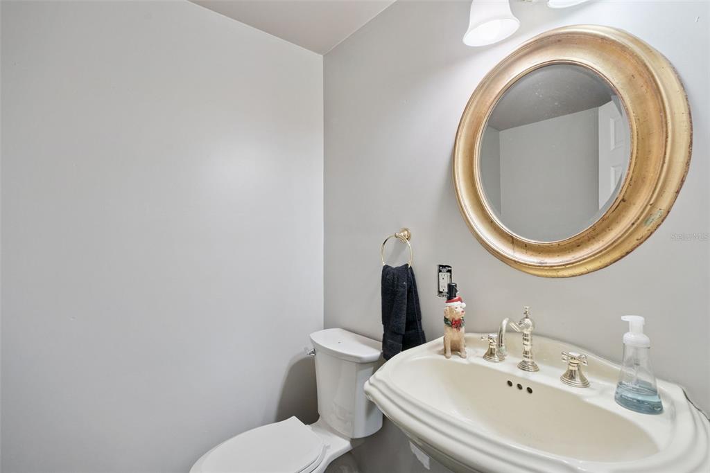 1048 North Grandview Street Mount Dora, FL 32757 - Photo 26 of 56 a bathroom with a sink and a mirror