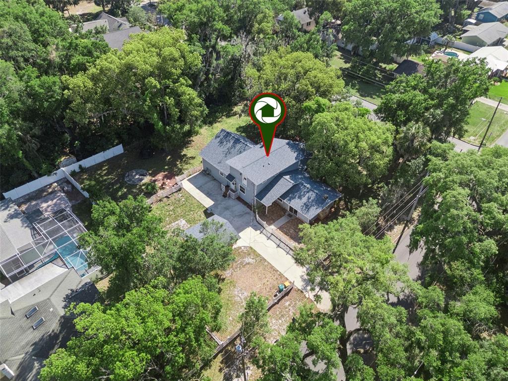 1048 North Grandview Street Mount Dora, FL 32757 - Photo 51 of 56 an aerial view of a house with yard