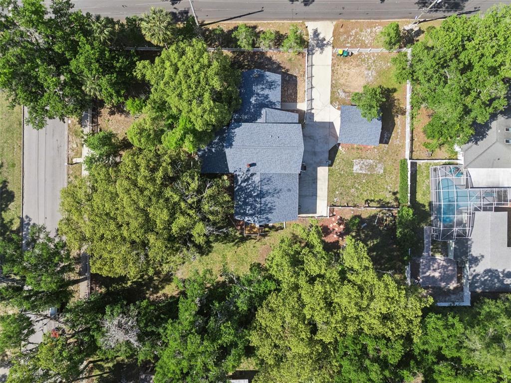 1048 North Grandview Street Mount Dora, FL 32757 - Photo 52 of 56 an aerial view of a house with a yard