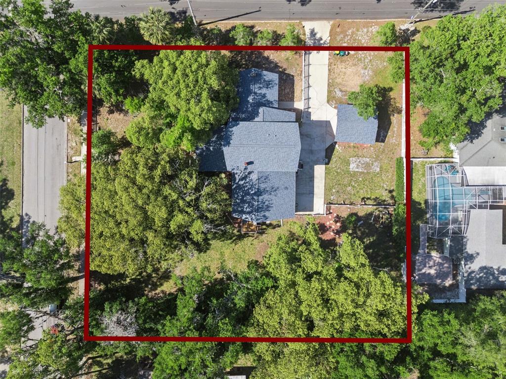 1048 North Grandview Street Mount Dora, FL 32757 - Photo 53 of 56 an aerial view of a house with a yard and garden