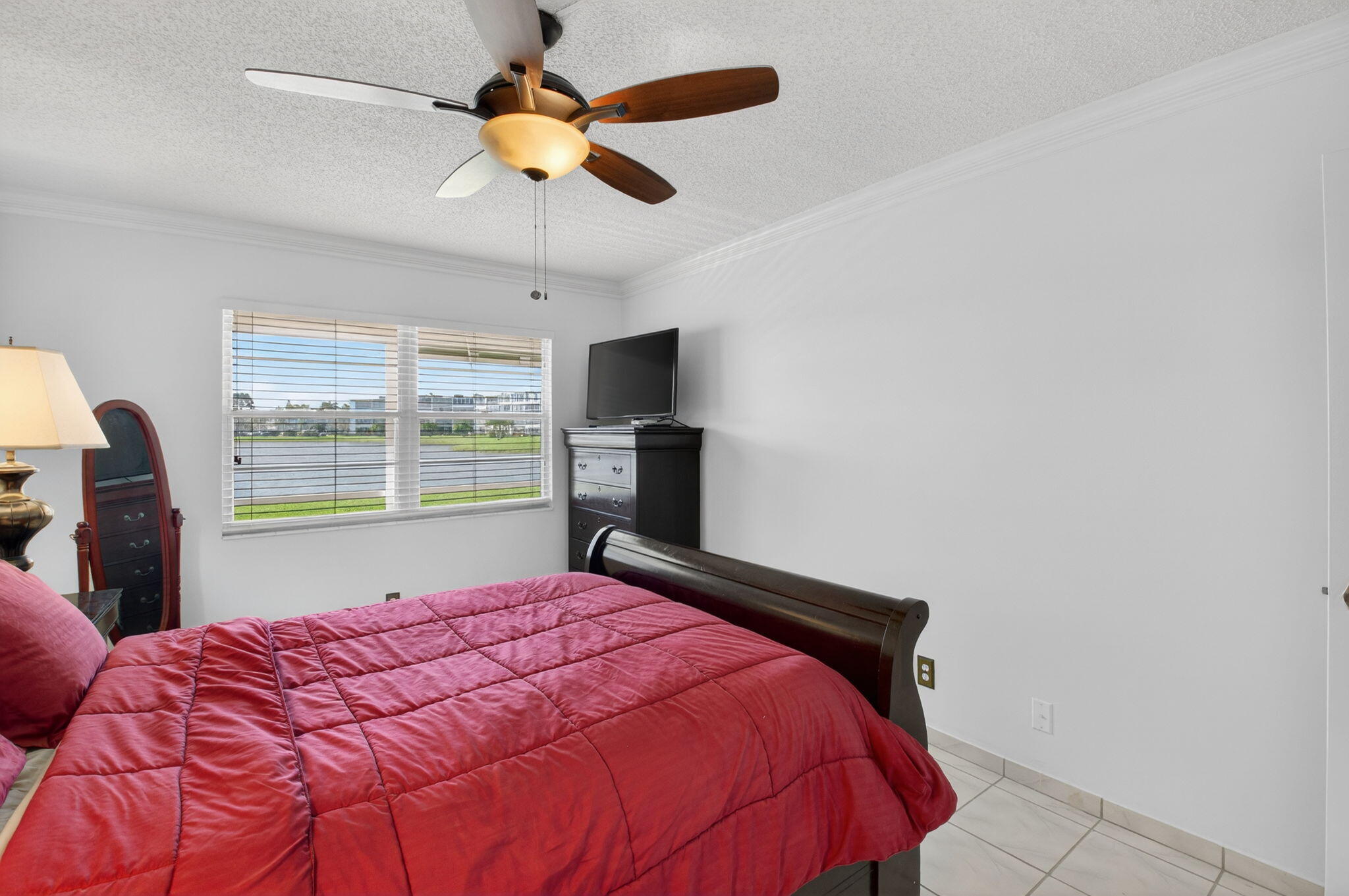1056 Guildford East, Unit 1056 Boca Raton, FL 33434 - Photo 12 of 57 a bedroom with a bed and a window