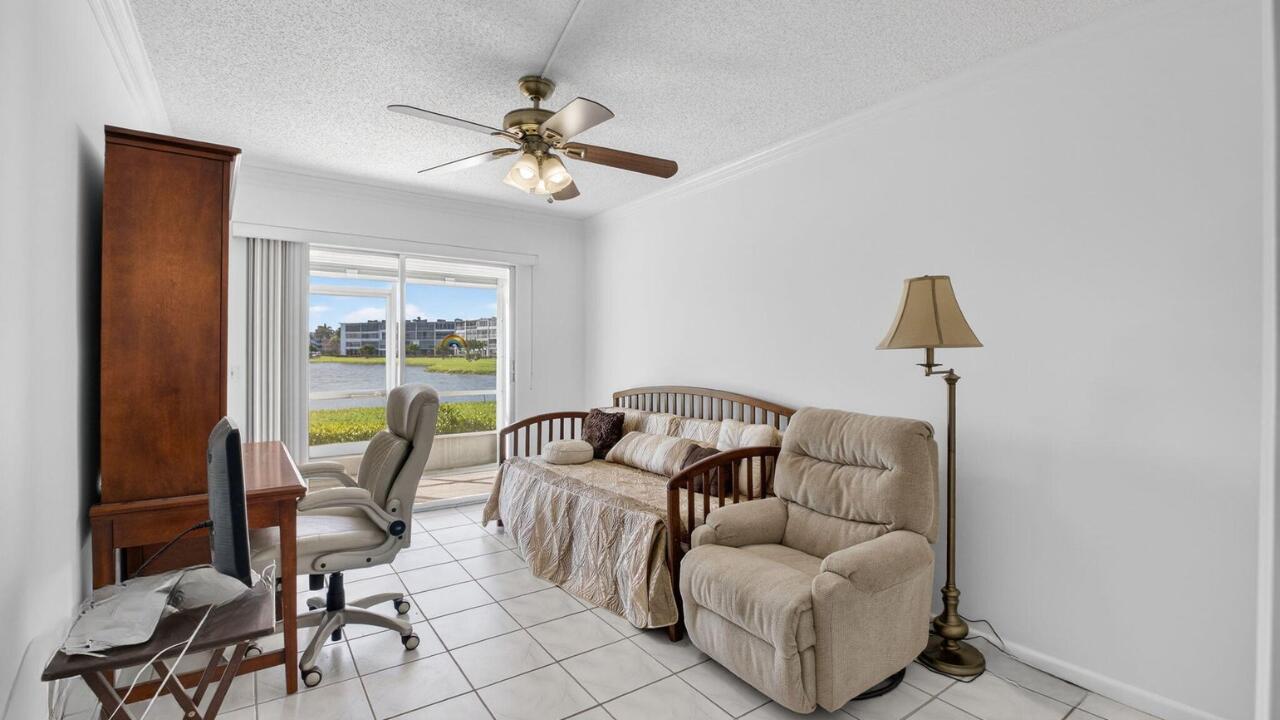 1056 Guildford East, Unit 1056 Boca Raton, FL 33434 - Photo 14 of 57 a living room with furniture and a window