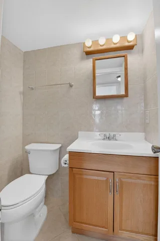 a bathroom with a sink a toilet and mirror