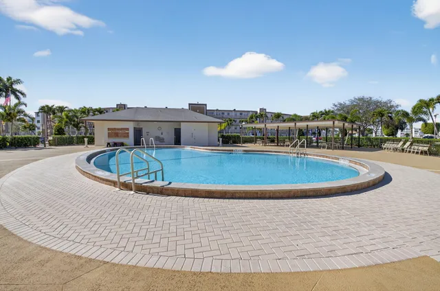 a view of a swimming pool with a table and chairs