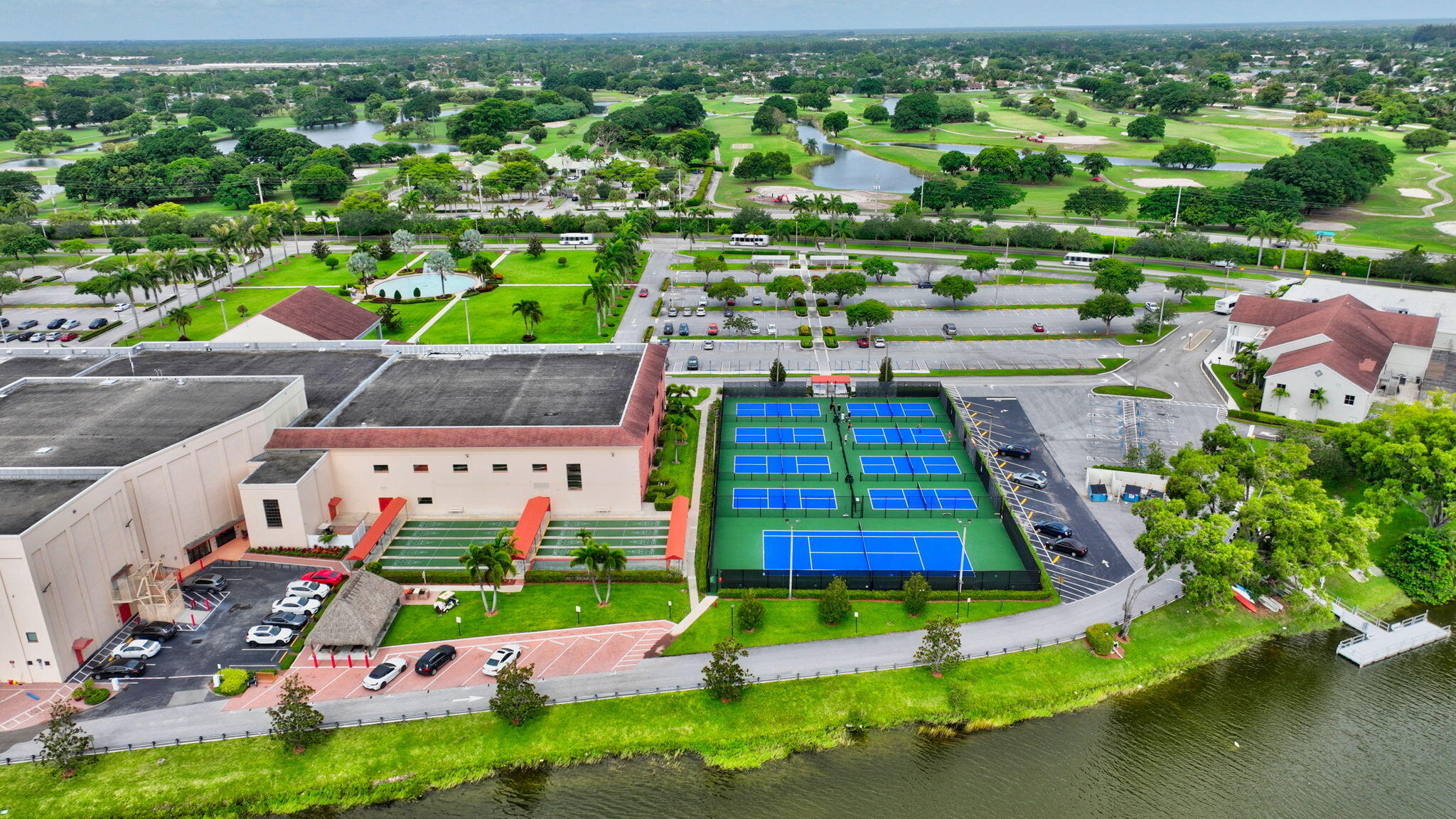 1056 Guildford East, Unit 1056 Boca Raton, FL 33434 - Photo 54 of 57 an aerial view of a tennis ground and large trees