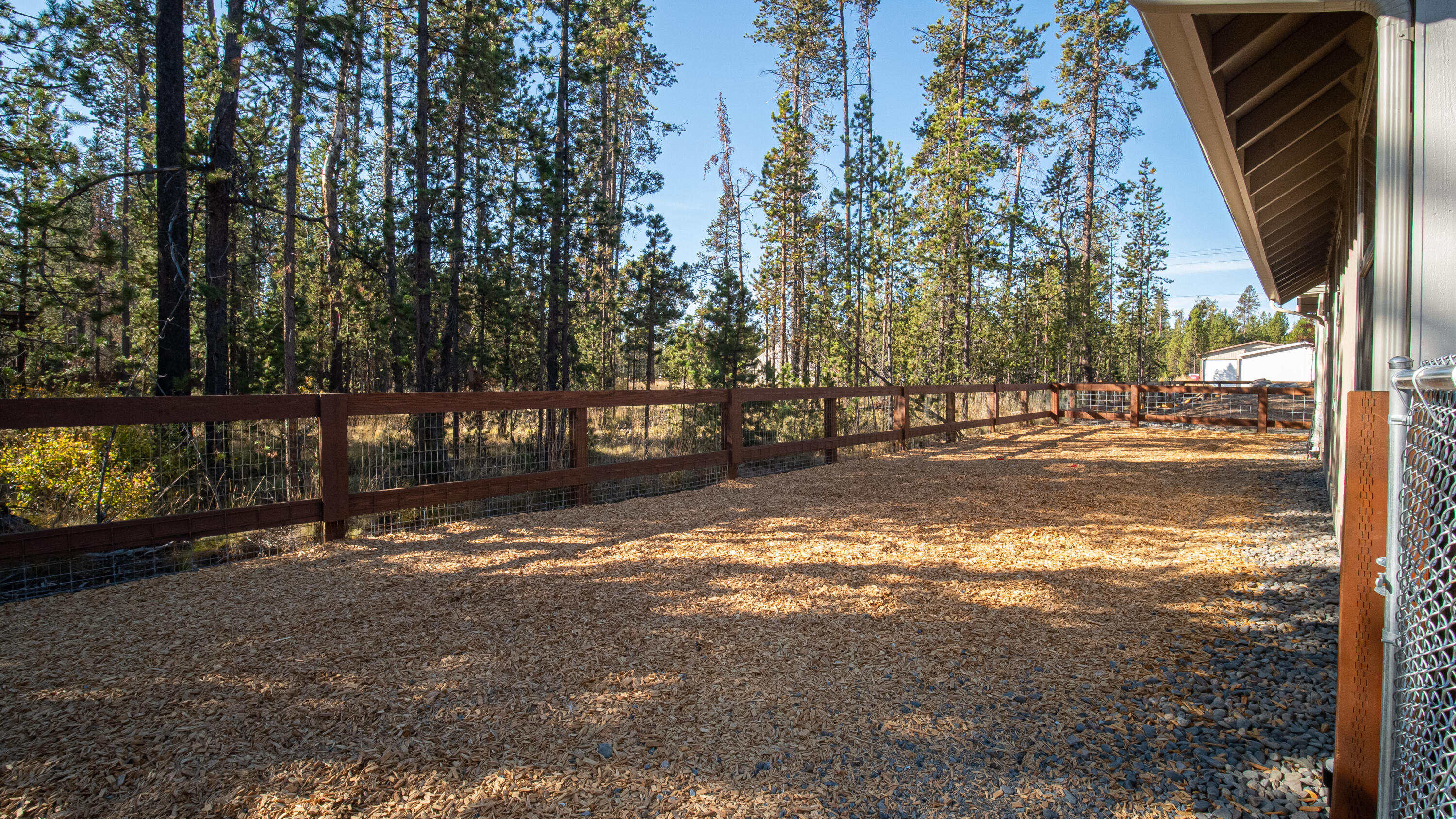 17201 Bakersfield Road Bend, OR 97707 - Photo 51 of 57 Massive bark chip dog run along the backside of the property