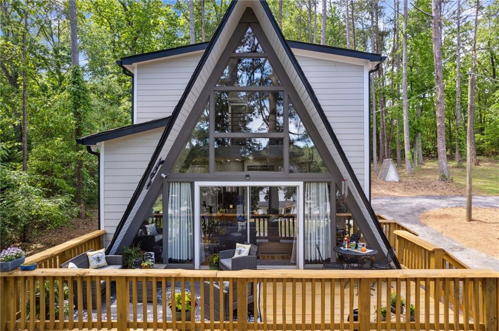 3570 Beaver Cove Road Cumming, GA 30041 - Photo 1 of 1 a view of small house with large windows