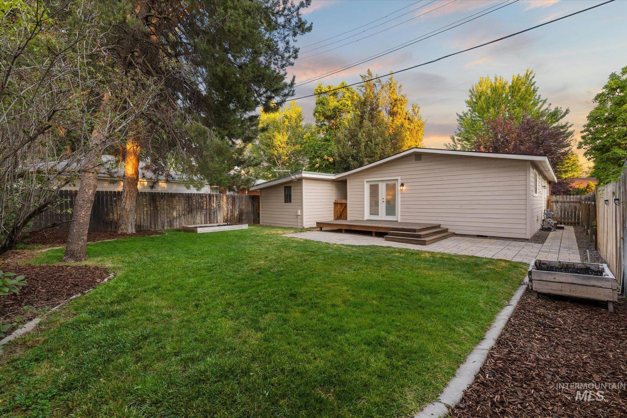 2302 Pendleton Street Boise, ID 83705 - Photo 32 of 35 Expansive backyard featuring a manicured lawn, wood fencing, and mature trees